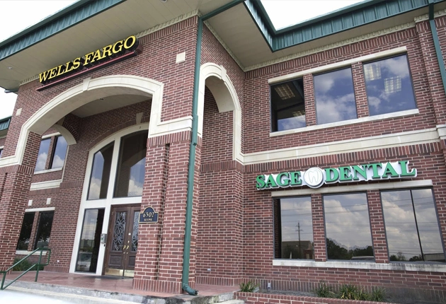 Exterior of Wells Fargo bank building with brick facade and Sage Dental signage visible on storefront.